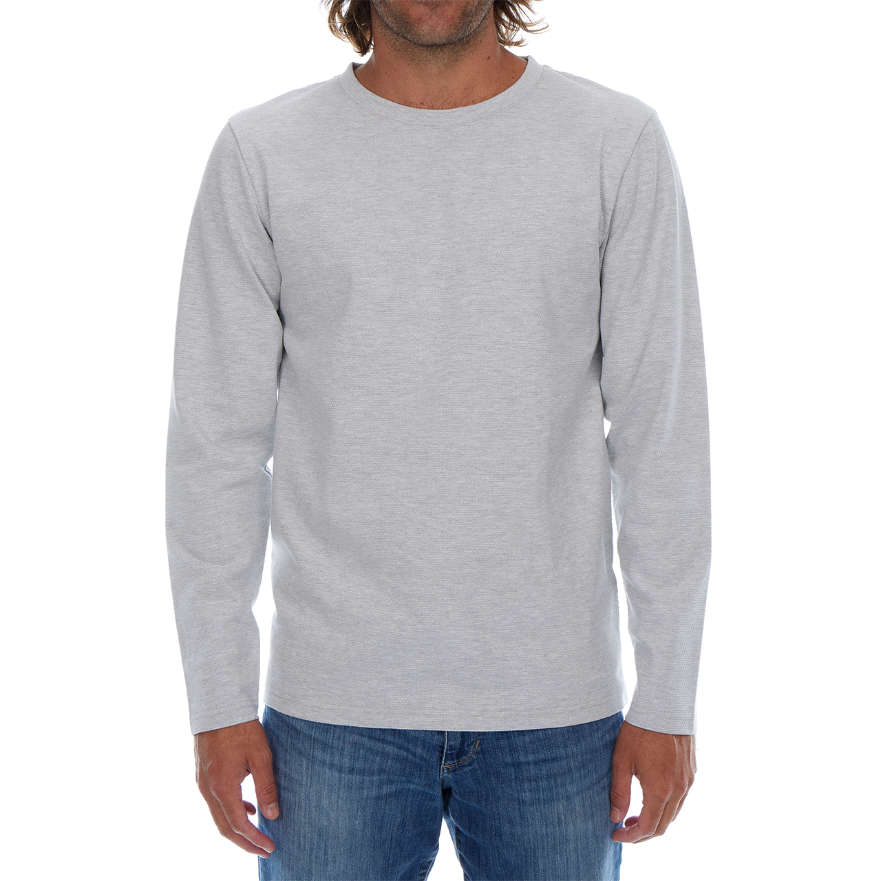 Man wearing a gray long-sleeve shirt and blue jeans on a white background