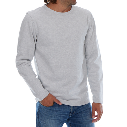 Person wearing a gray long-sleeve shirt and blue jeans on a white background