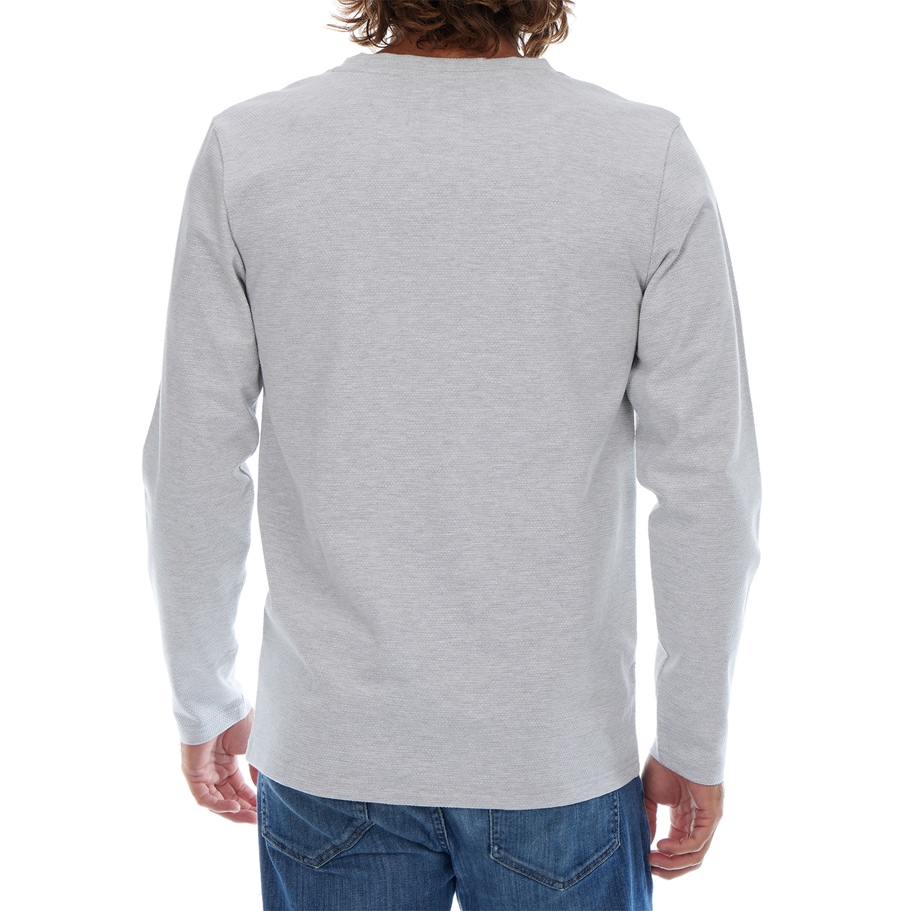 Person wearing a gray long-sleeve shirt and blue jeans on a white background