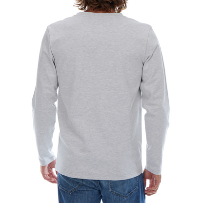 Person wearing a gray long-sleeve shirt and blue jeans on a white background
