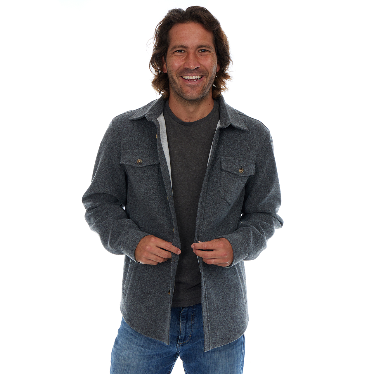 Man wearing a gray jacket over a dark shirt on a white background