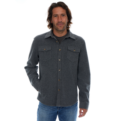 Man wearing a dark gray flannel shirt with a white background