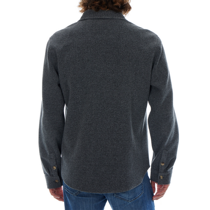 Person wearing a dark gray shirt with long sleeves on a white background
