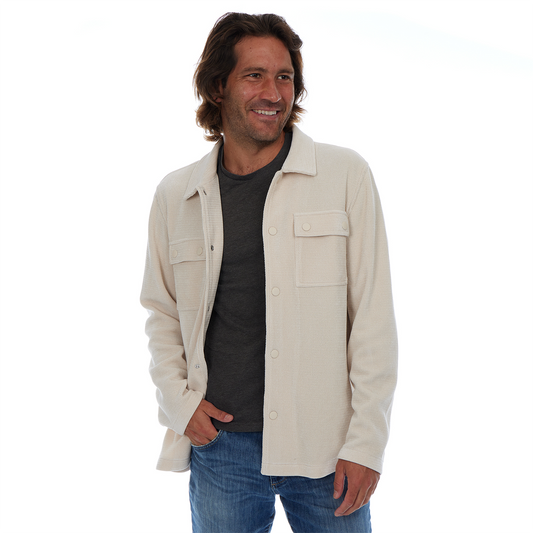 Man wearing a beige jacket over a black shirt on a white background