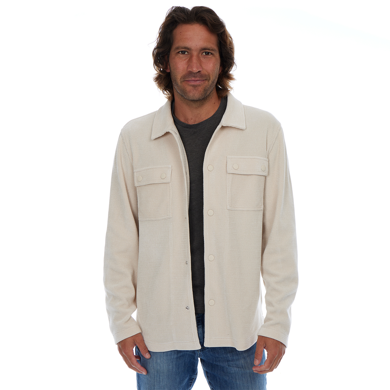 Man wearing a beige jacket over a black shirt on a white background