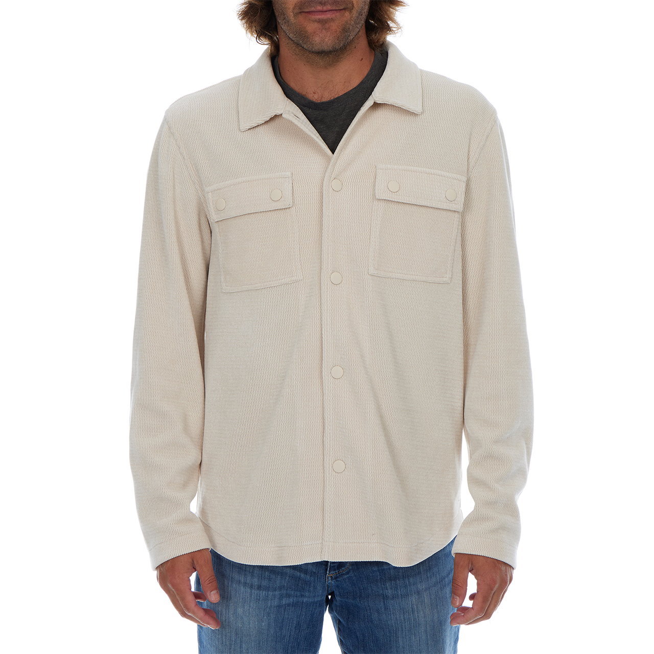 Man wearing a beige button-up shirt with a white background