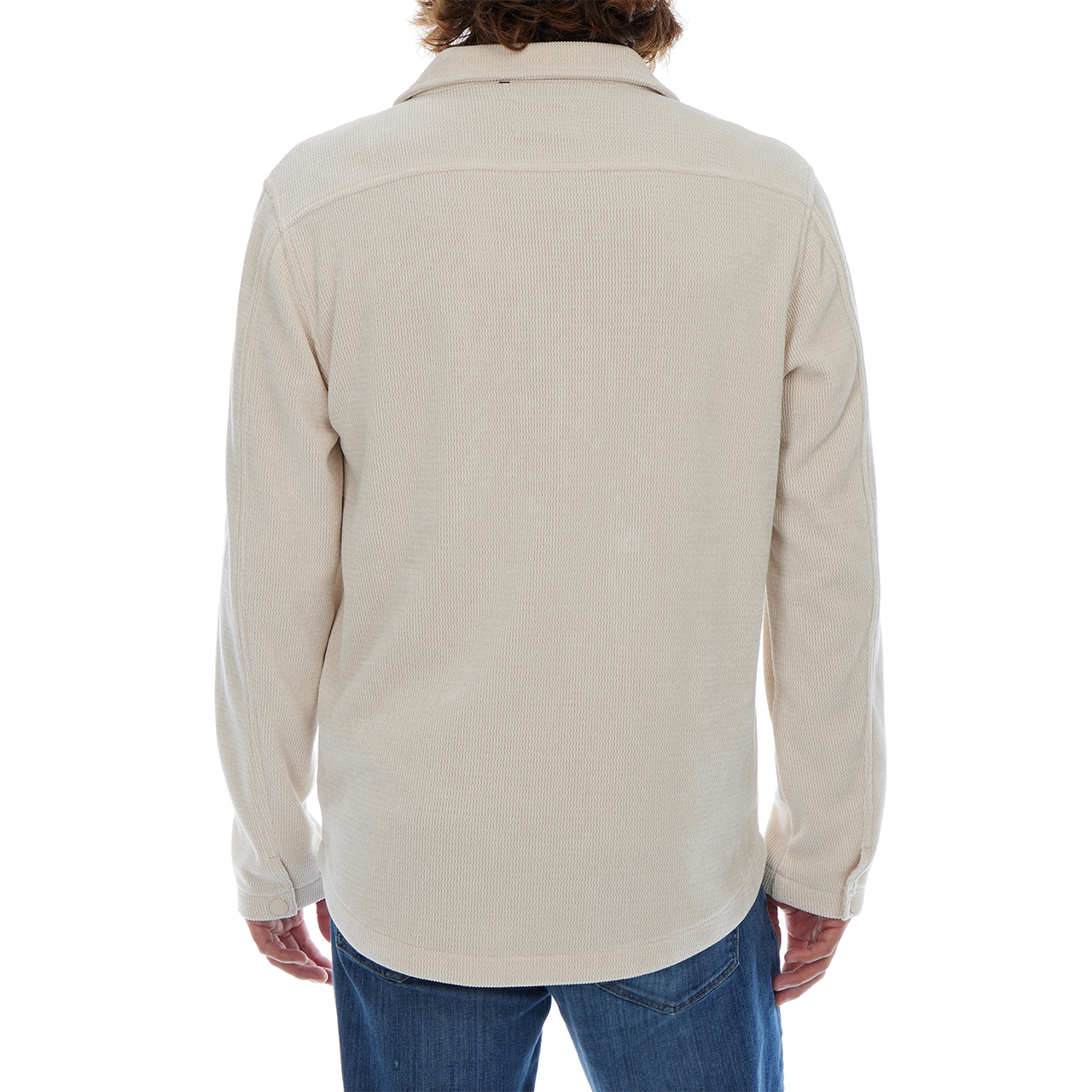Person wearing a beige long-sleeve shirt on a white background