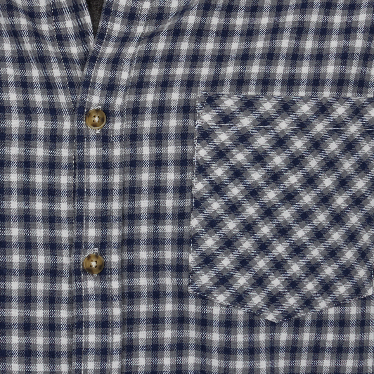 Close-up of a blue and white checkered shirt with buttons and a pocket.