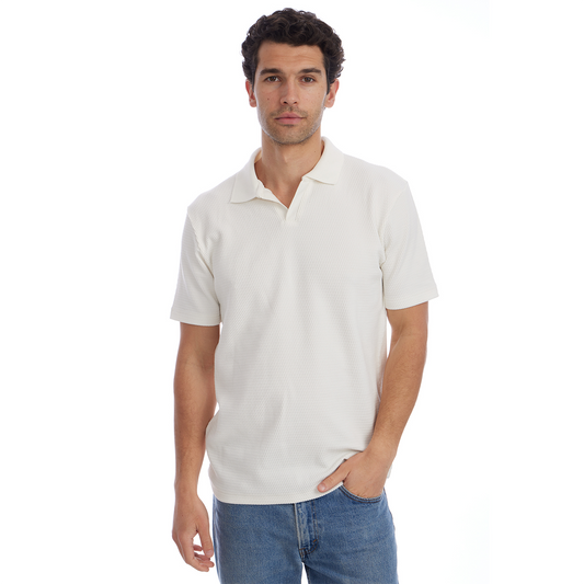 Man wearing a plain white polo shirt and blue jeans on a white background