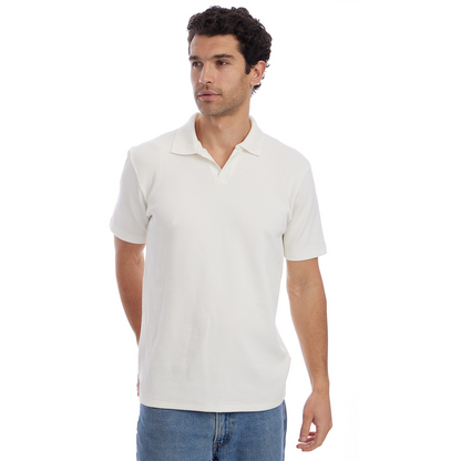 Man wearing a white polo shirt and blue jeans on a white background