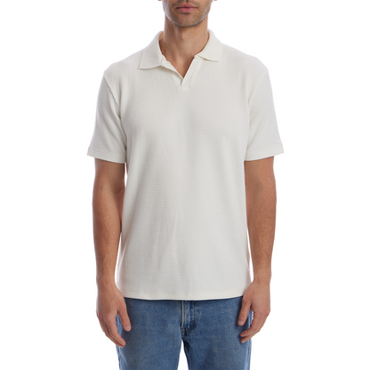Man wearing a textured white polo shirt and blue jeans on a white background