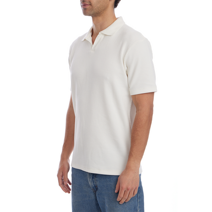 Man wearing a white polo shirt and blue jeans on a white background