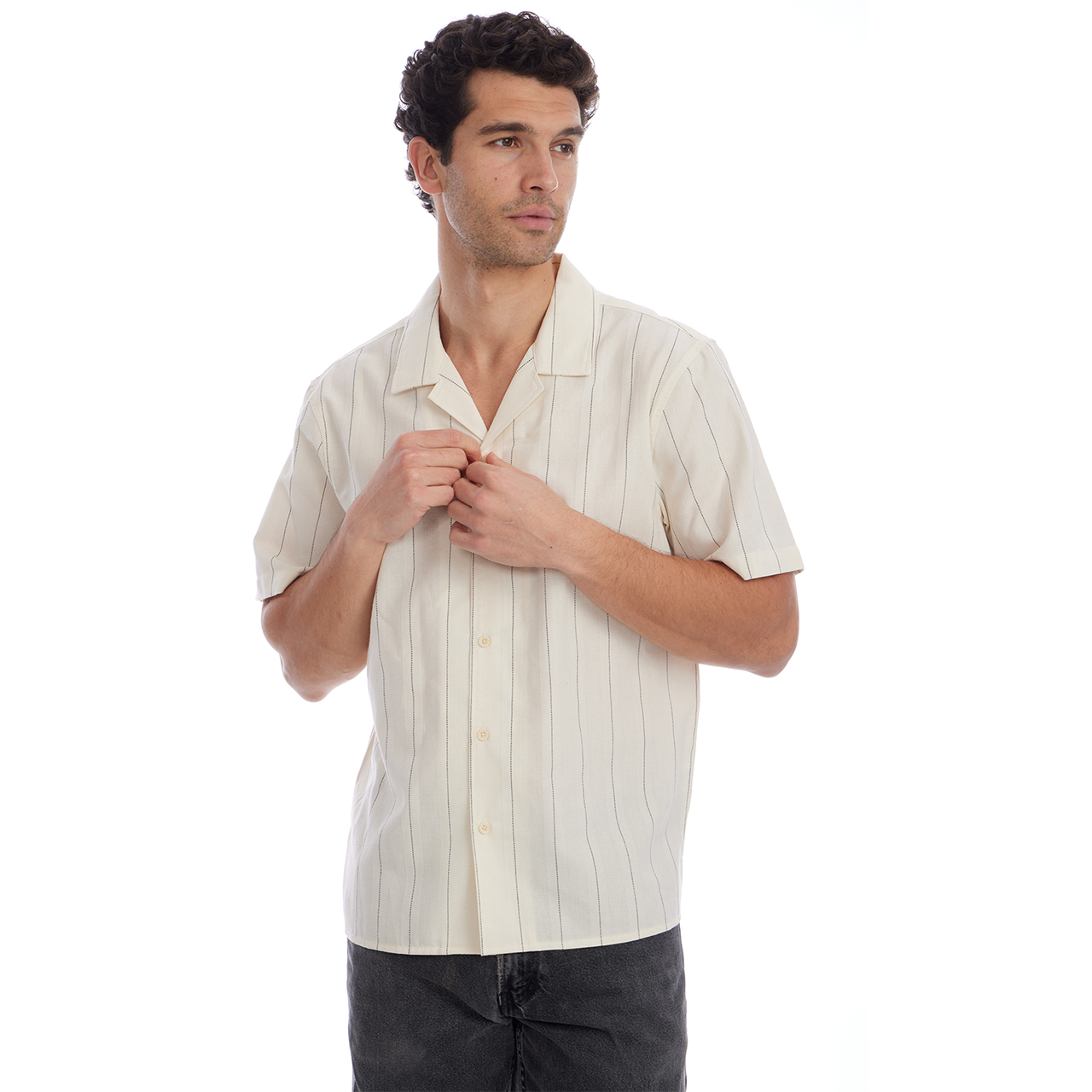 Man wearing a beige short-sleeve shirt with vertical stripes on a white background