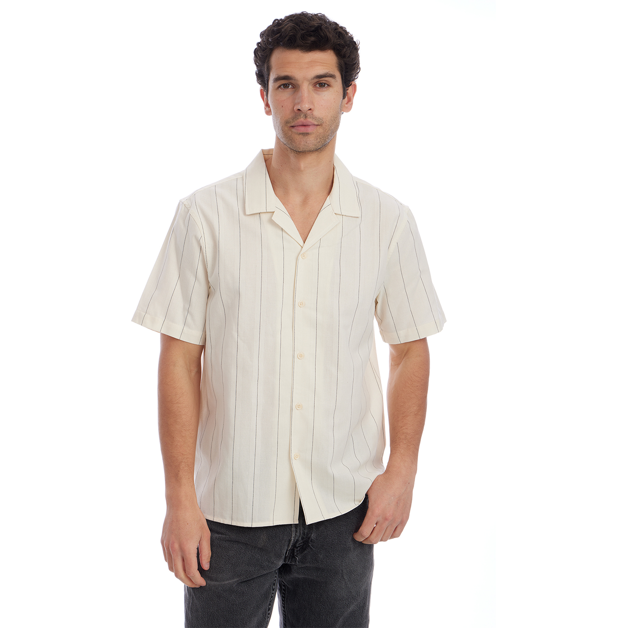 Man wearing a cream-colored short-sleeve shirt with vertical stripes on a white background