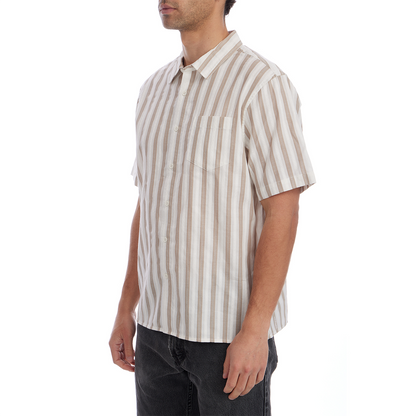 Man wearing a beige and white striped shirt on a white background
