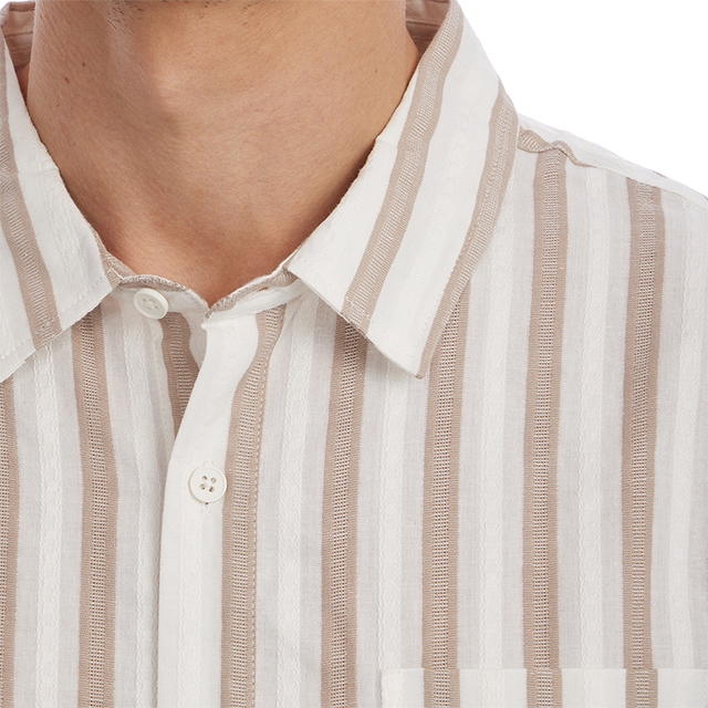 Close-up of a person wearing a beige and white striped shirt.