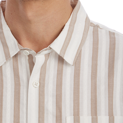 Close-up of a person wearing a beige and white striped shirt.
