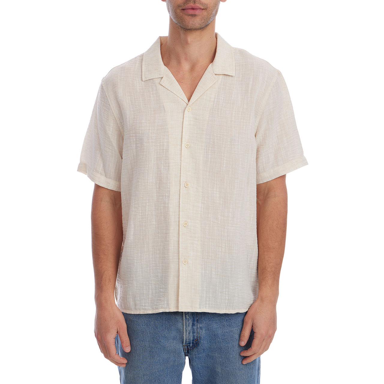 Man wearing a beige short-sleeve shirt and blue jeans on a white background