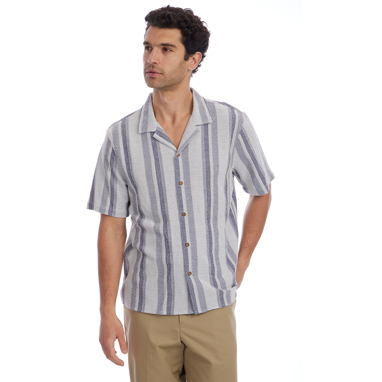 Man wearing a striped shirt and beige pants on a white background