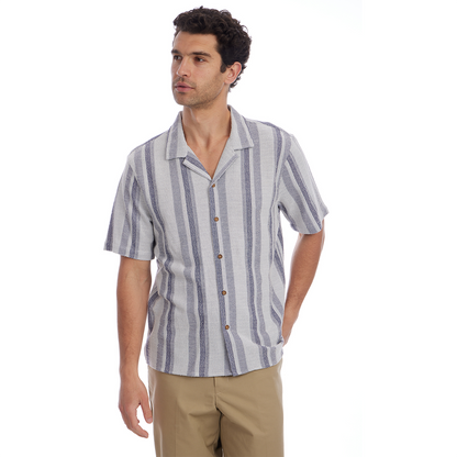 Man wearing a striped shirt and beige pants on a white background