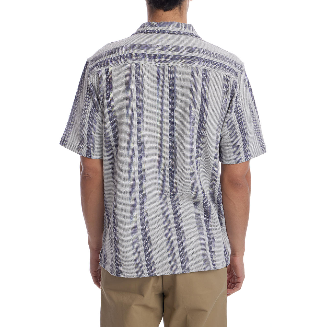 Person wearing a striped shirt and beige pants on a white background