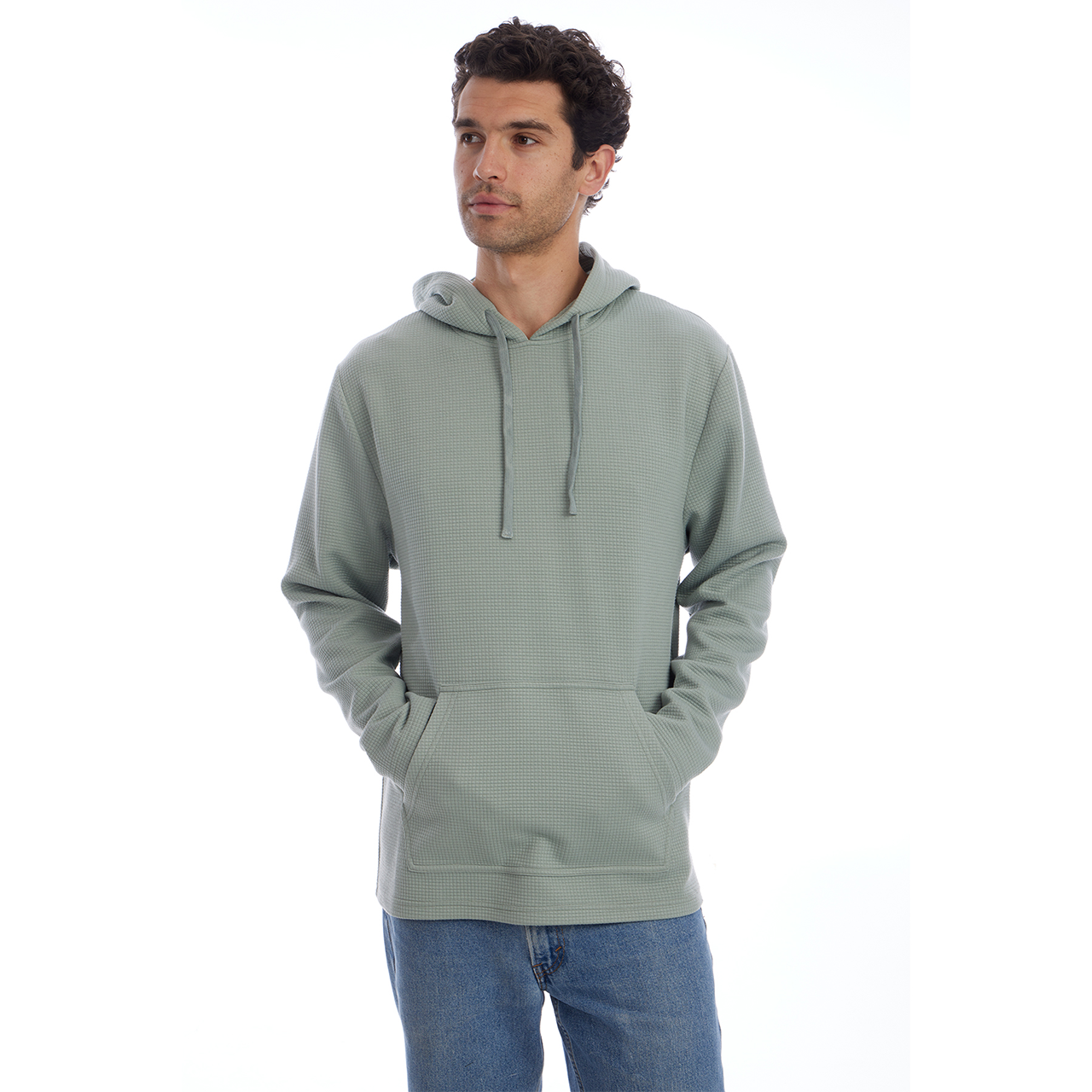 Man wearing a light gray hoodie and blue jeans on a white background