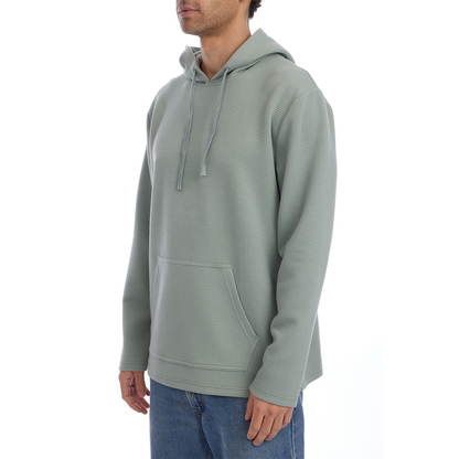 Person wearing a light green hoodie on a white background