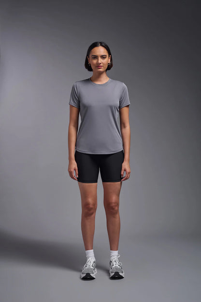 Person wearing a gray t-shirt and black shorts on a gray background
