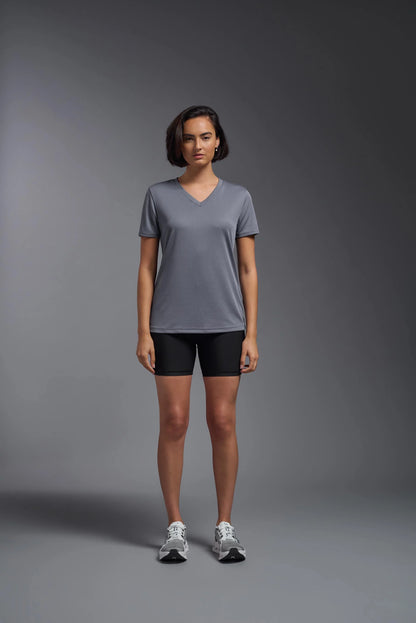 Person wearing a gray t-shirt and black shorts on a gray background