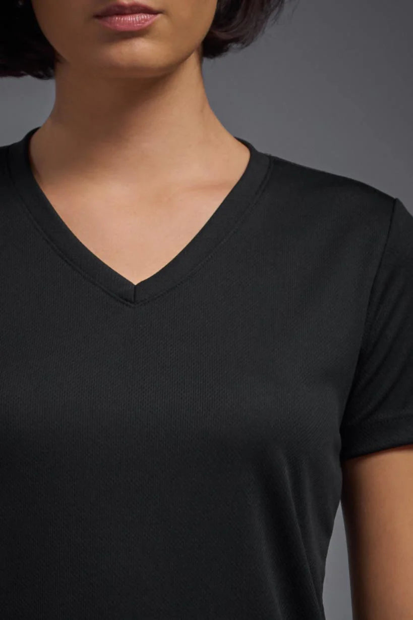 Person wearing a black V-neck t-shirt against a gray background