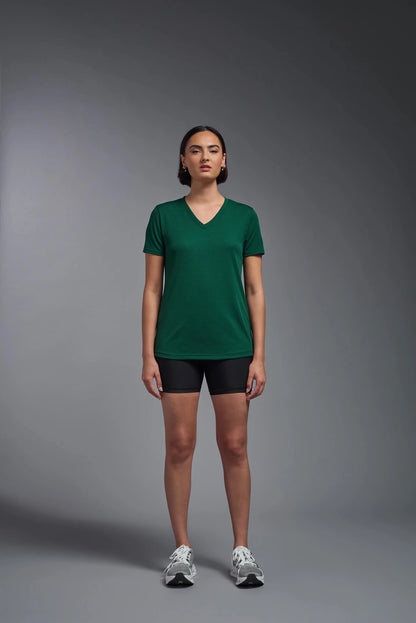 Person wearing a green t-shirt and black shorts on a gray background