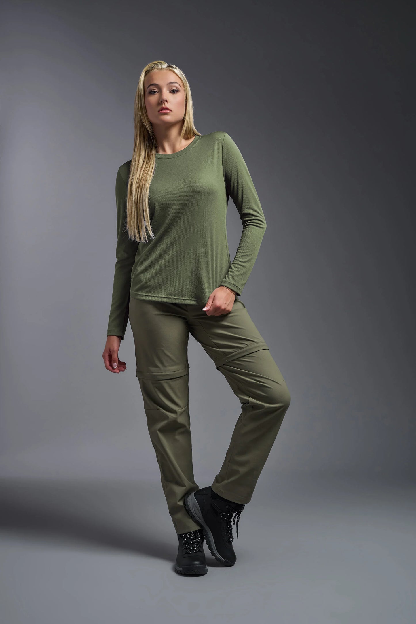 Woman wearing a green outfit on a gray background