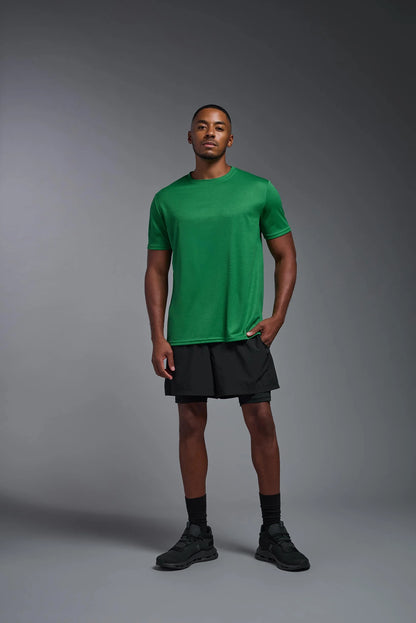 Man wearing a green athletic shirt and black shorts against a gray background