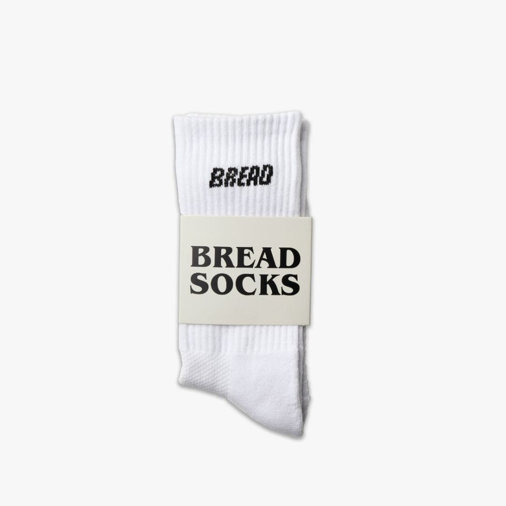 White ribbed crew socks with bold black “BREAD” logo on the cuff
