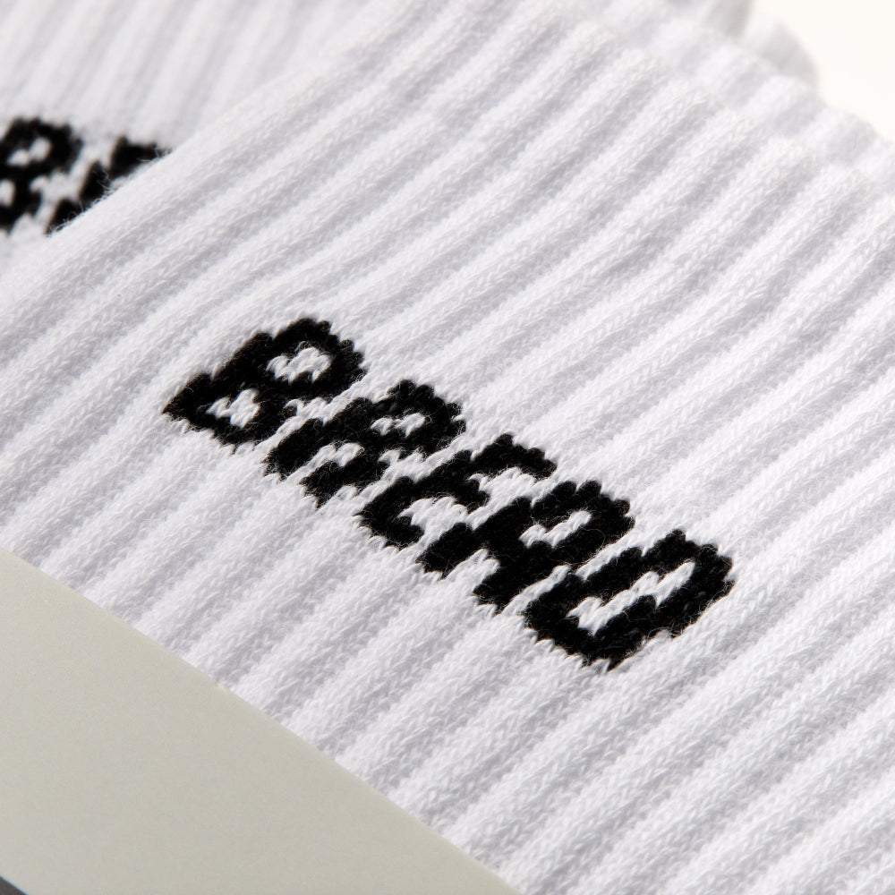 White ribbed knit crew socks with black “BREAD” logo embroidery