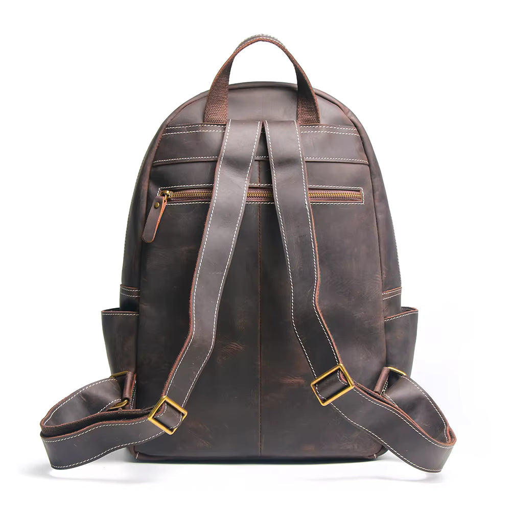 Brown leather backpack with gold zippers on a white background