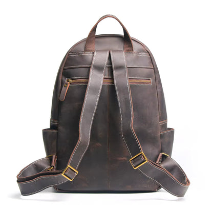 Brown leather backpack with gold zippers on a white background