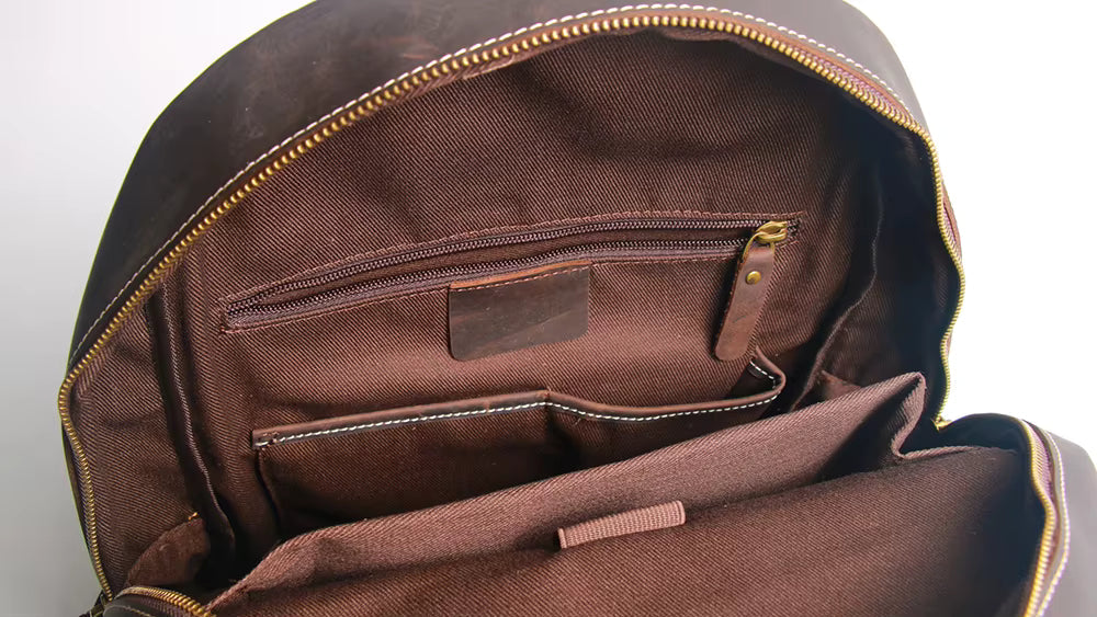 Brown backpack with open front pocket on a white background