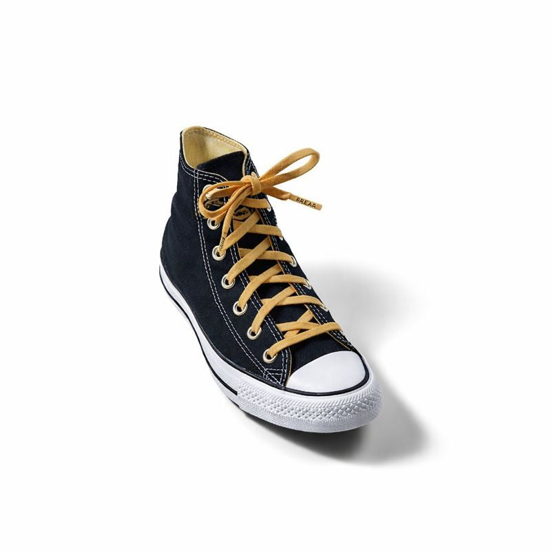 Black high-top sneaker with yellow laces on a white background