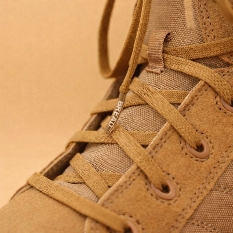 Close-up of a brown boot with laces on a beige background