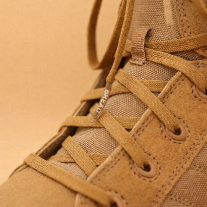 Close-up of a brown boot with laces on a beige background