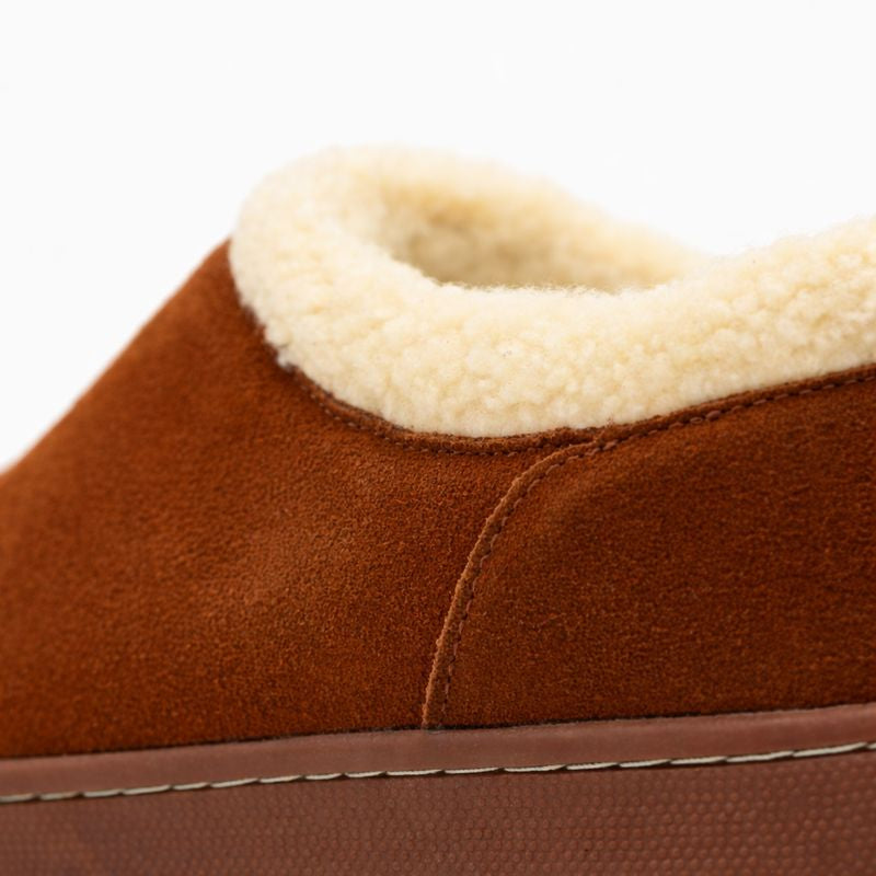 Brown slipper with beige interior on a white background