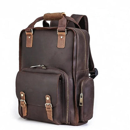 Dark brown leather camera backpack with zip front pocket and side carry straps