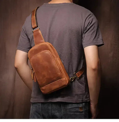 Brown leather crossbody pack worn on body with adjustable shoulder strap