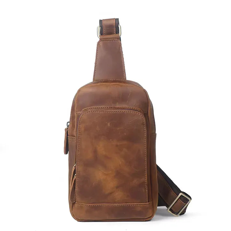 Brown leather crossbody sling bag with top handle and adjustable shoulder strap