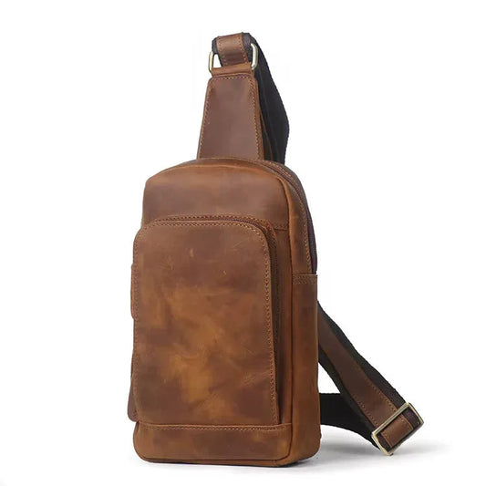 Brown leather crossbody sling bag with front pocket and adjustable shoulder strap