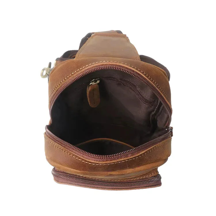 Brown leather crossbody pack front view, open mouth with inner zip pocket detail
