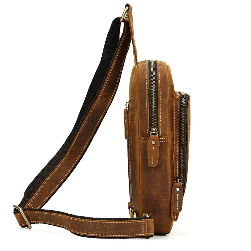 Brown leather crossbody sling bag with adjustable strap and two front zip compartments