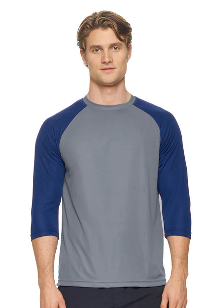Man wearing a gray and blue baseball shirt on a white background