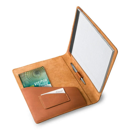 Brown leather padfolio open, pen loop and card holder visible